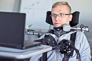 student in wheelchair with speaking assistive tech