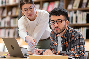 Photograph of two students working.