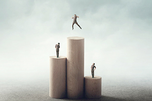 three pillars with people standing on them. the person on the highest podium is jumping with excitement