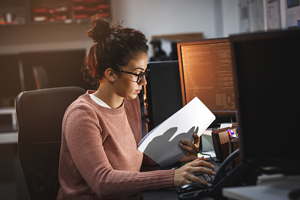 female works intently on a computer