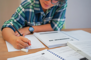 young student uses a pencil to take an exam