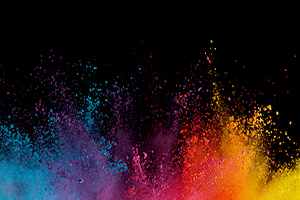 Splash of many color powders on a black background.