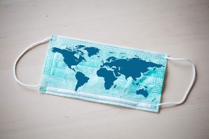 Protective face mask with map of the world on it.