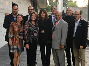 Group photo of several people who are all wearing business attire.