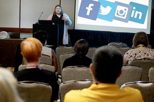 Female speaks to a break out session from behind a podium.