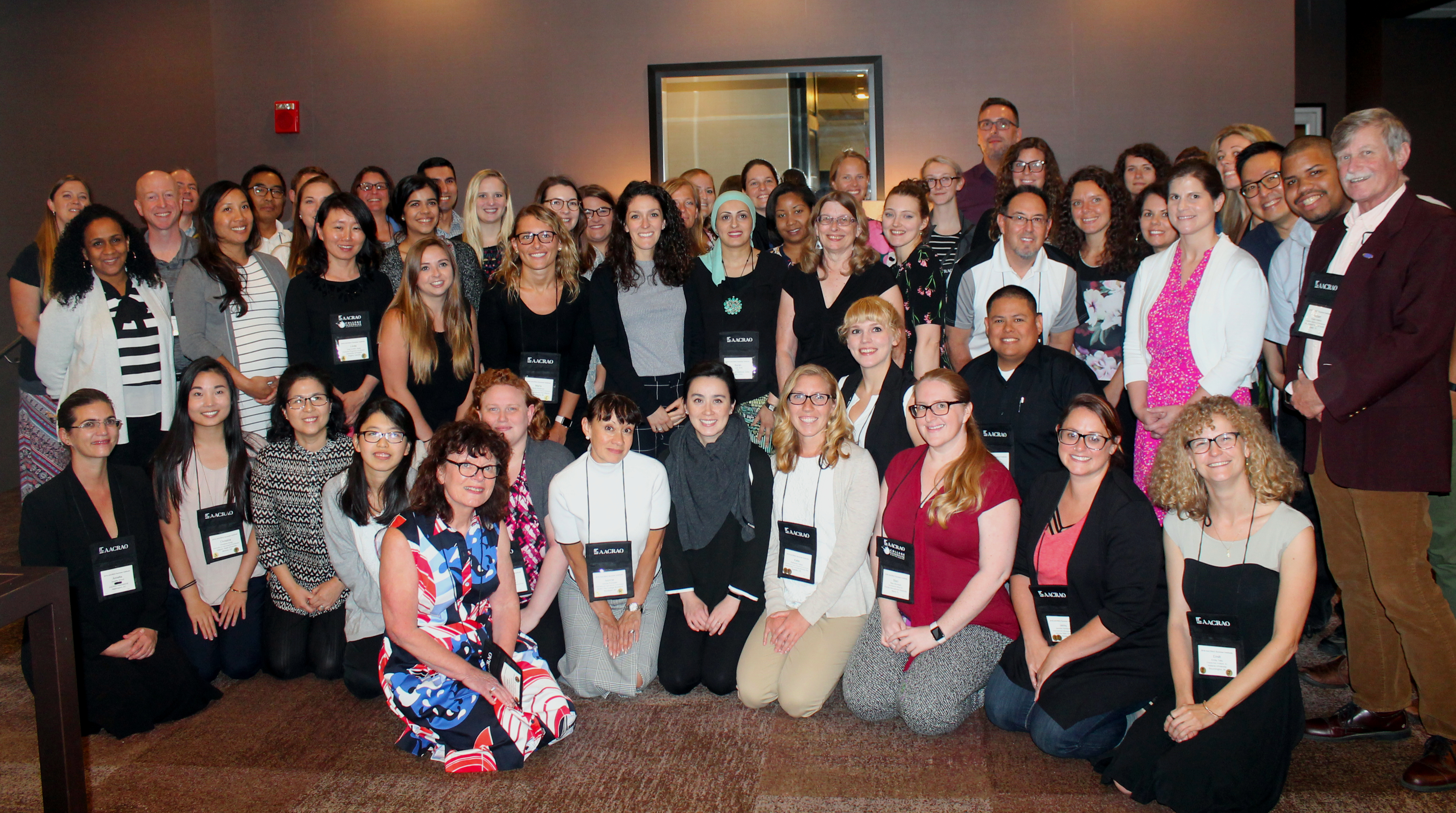 Large group photo of AACRAO members at a conference.