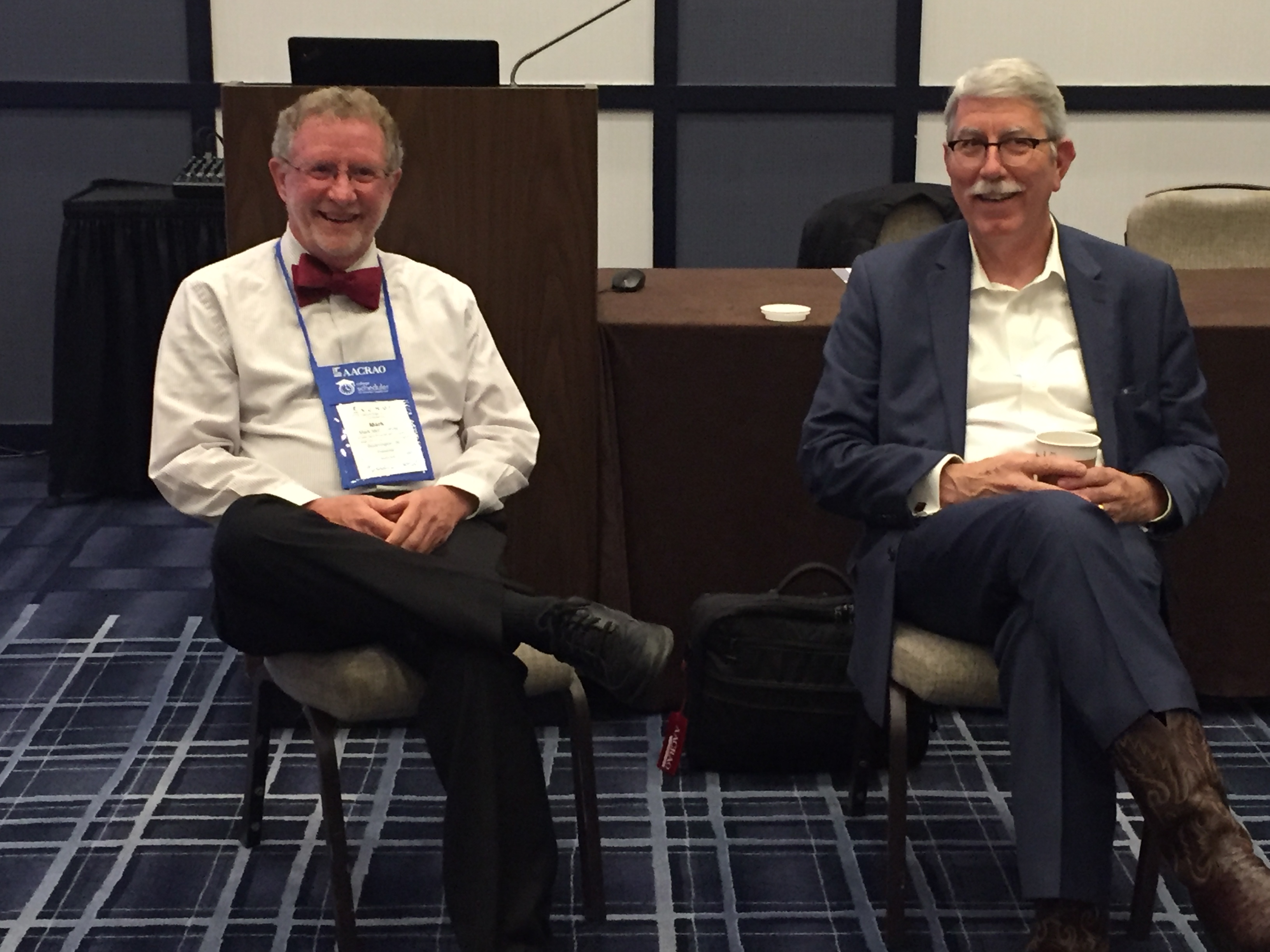 Photo of Mark McConahay (left) and Tom Black (right) smiling as they sit next to each other.