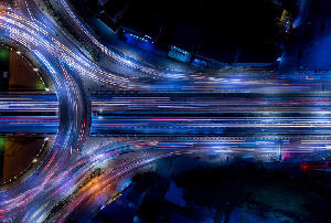 Aerial view of a highway made of streaking lines of light.