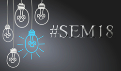 Group of Edison bulbs drawn in chalk next to the text "#SEM18".