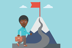 Cartoon male holding a computer bag while walking up a mountain with a red flag at the peak.