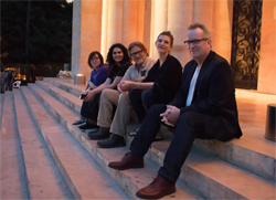 Photo of five AACRAO staff members sitting on a marble staircase.