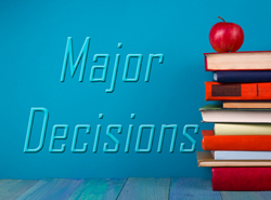 The words "major decisions" visible next to a stack of books with an apple perched on top. 