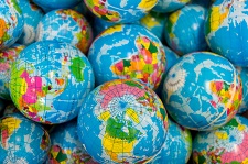 Photo of several small rubber balls decorated to look like global maps.