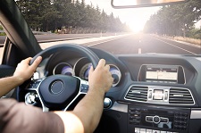 Person driving their car on a stretch of road with no other cars visible.