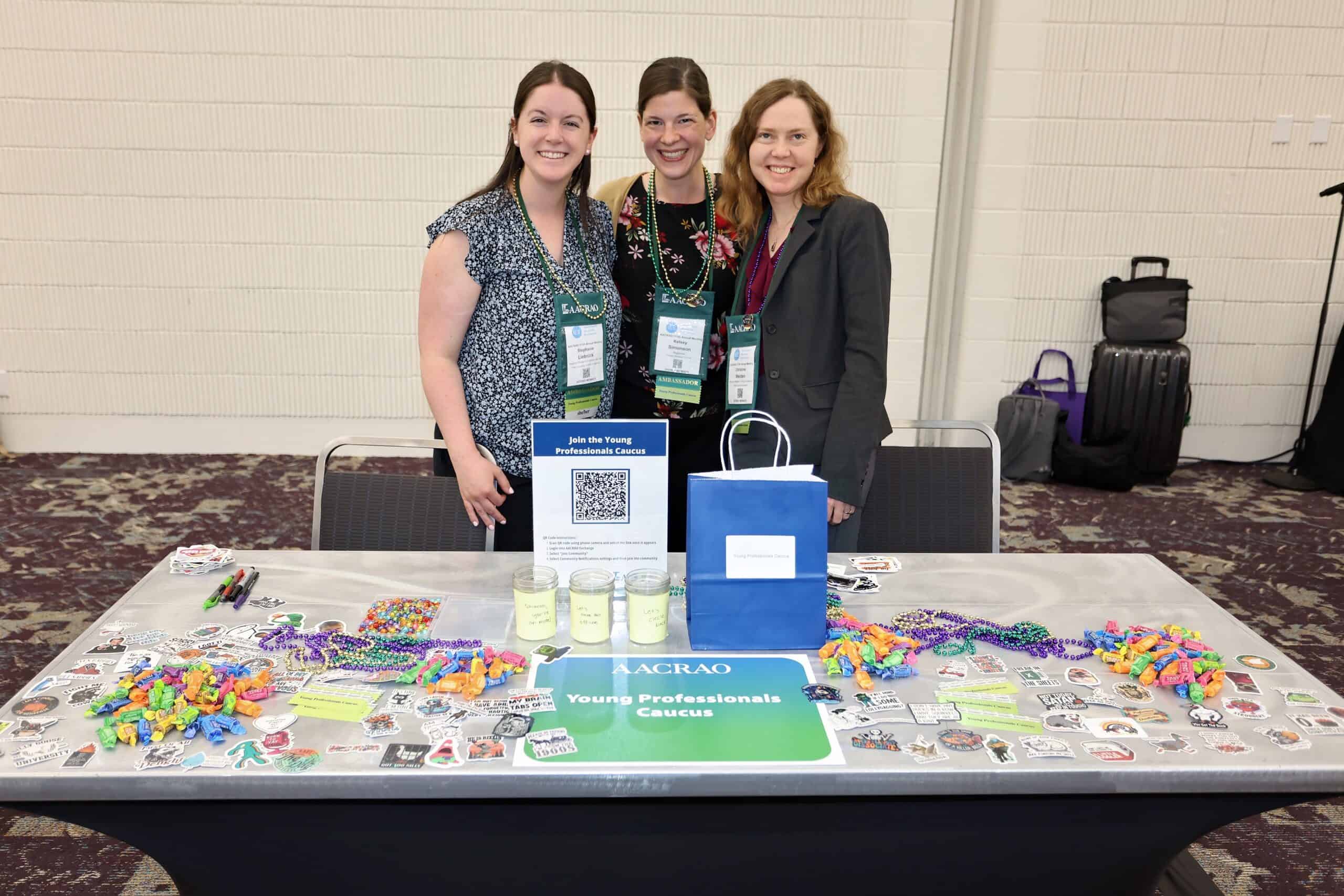 Three members at the AACRAO Young Professionals Caucus table