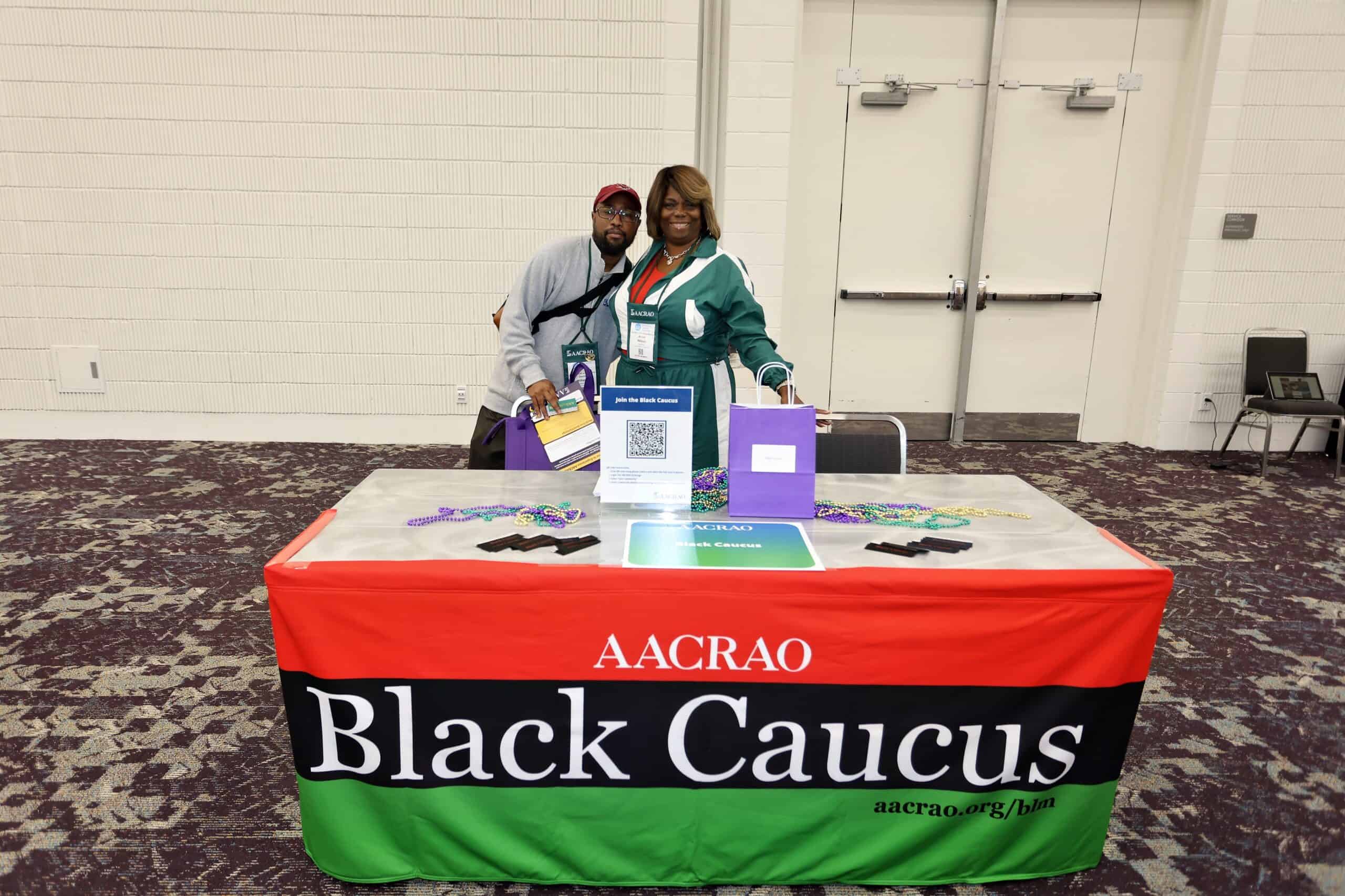 Two members at the AACRAO Black Caucus table