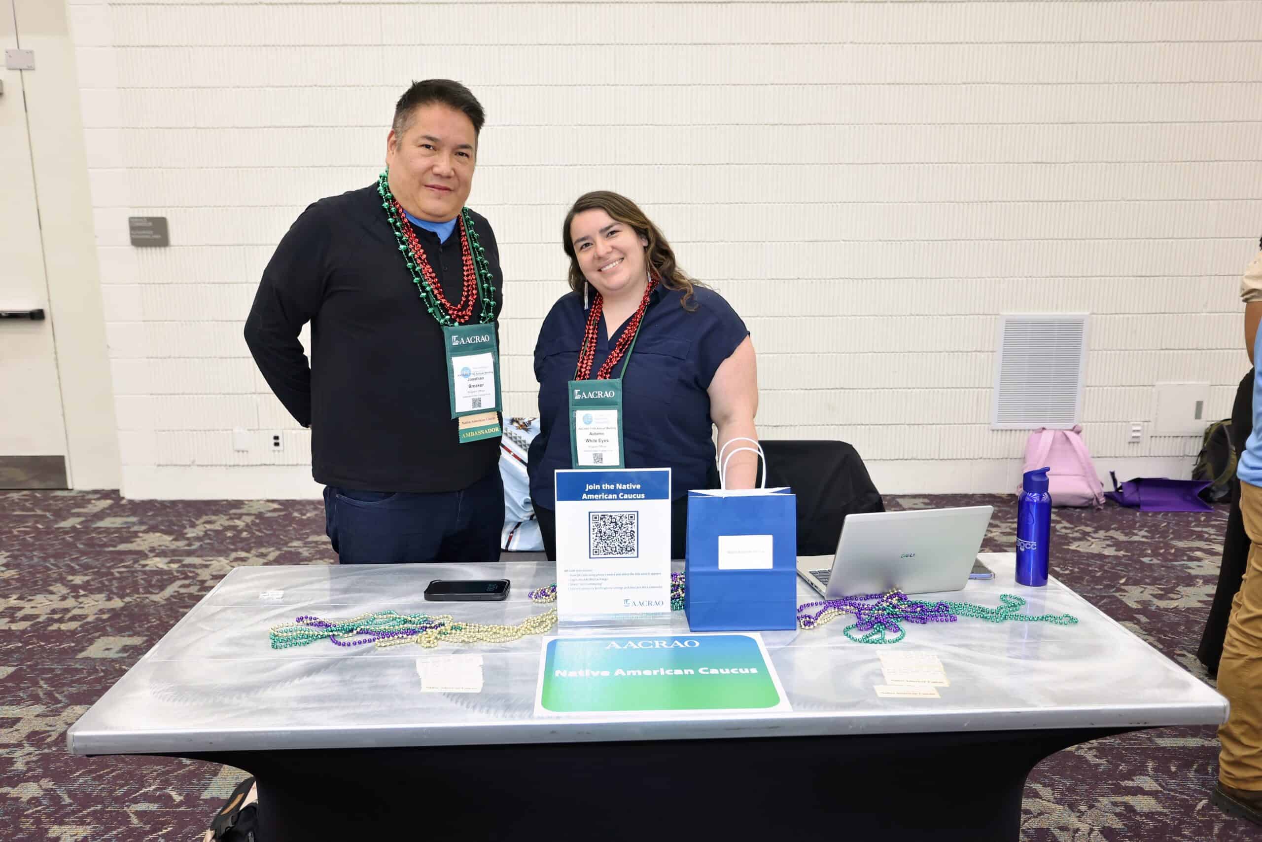 Two members at the AACRAO Native Americans Caucus table