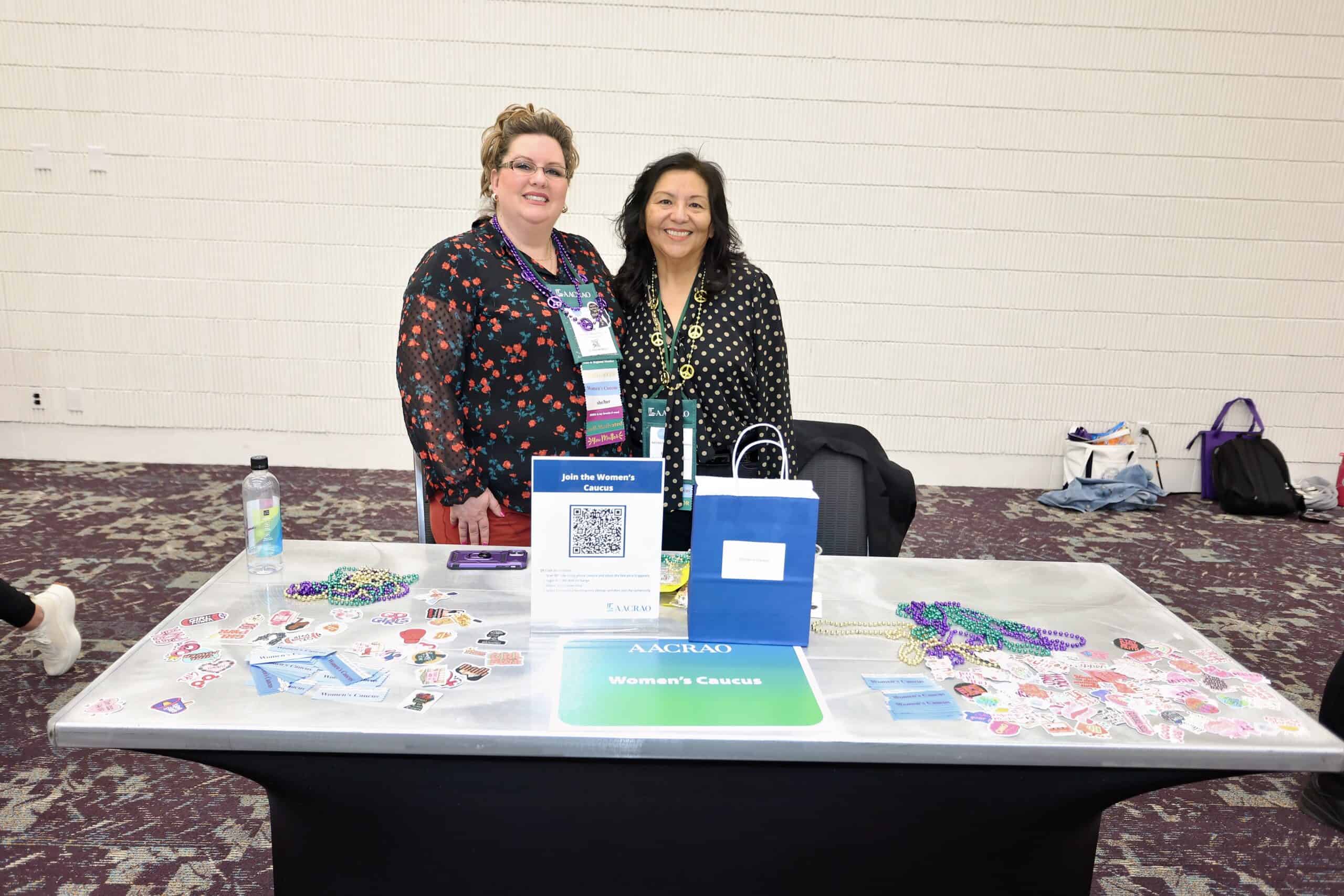 Two members at the AACRAO Women's Caucus table