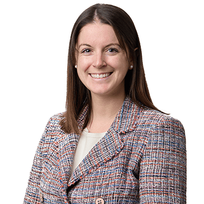 Smiling woman in a professional blazer, head-and-shoulders portrait