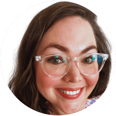 Portrait of a smiling woman wearing clear glasses