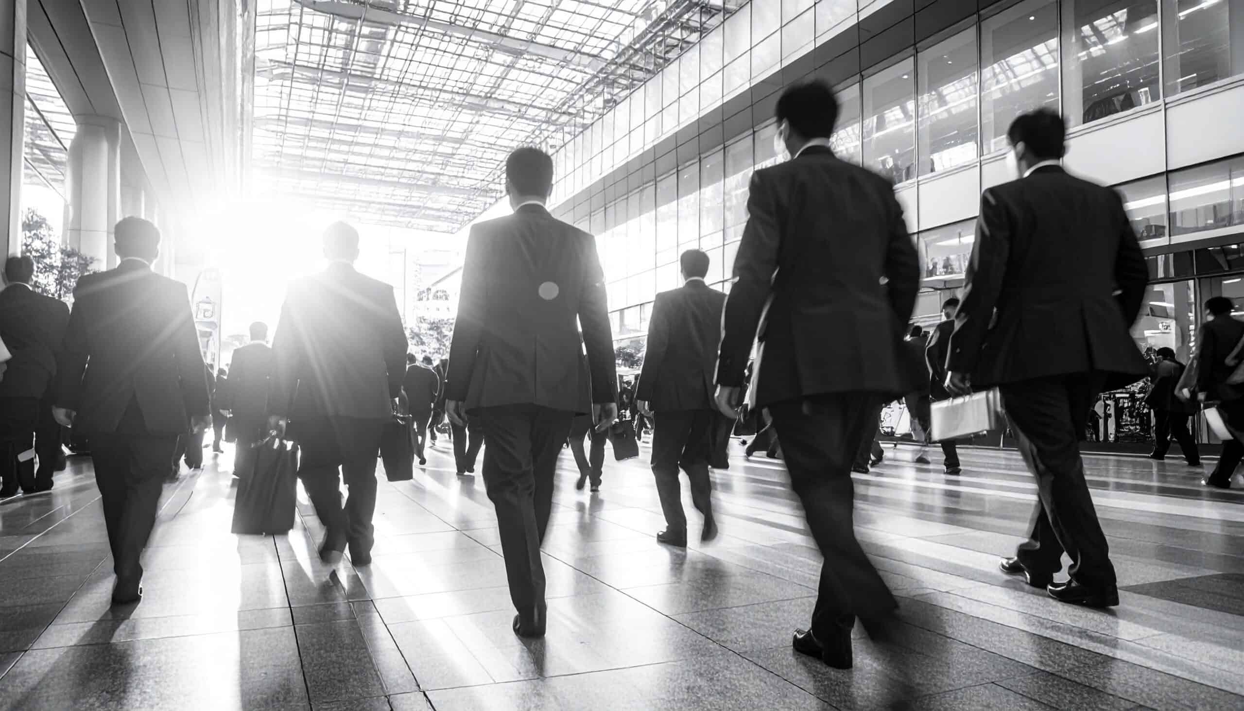 a crowd of people walking inside a building
