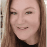 Portrait of a smiling woman with light brown hair