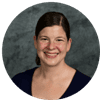 Portrait of a smiling woman against a gray background