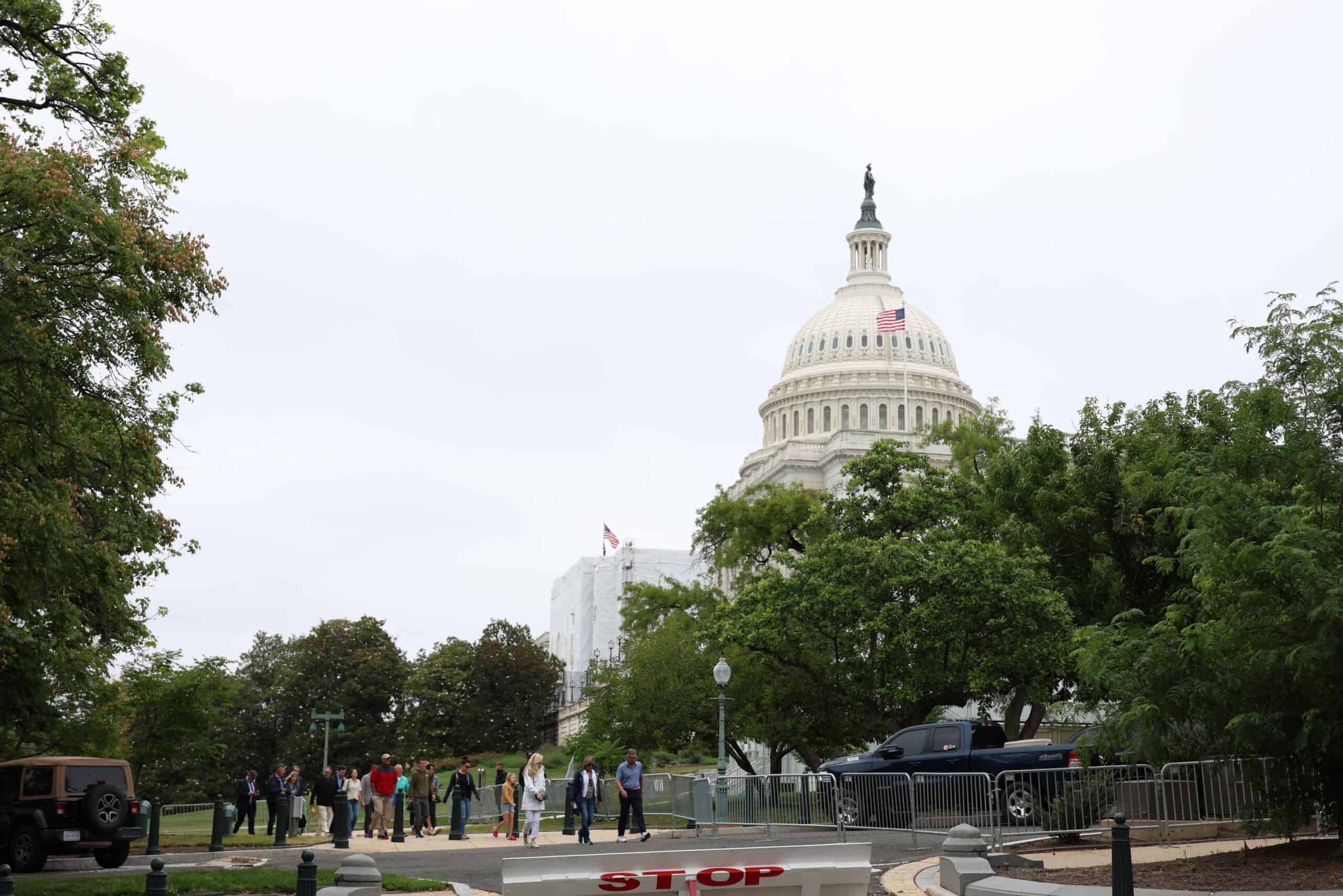U.S. Capitol with visitors and trees in Washington, D.C.
