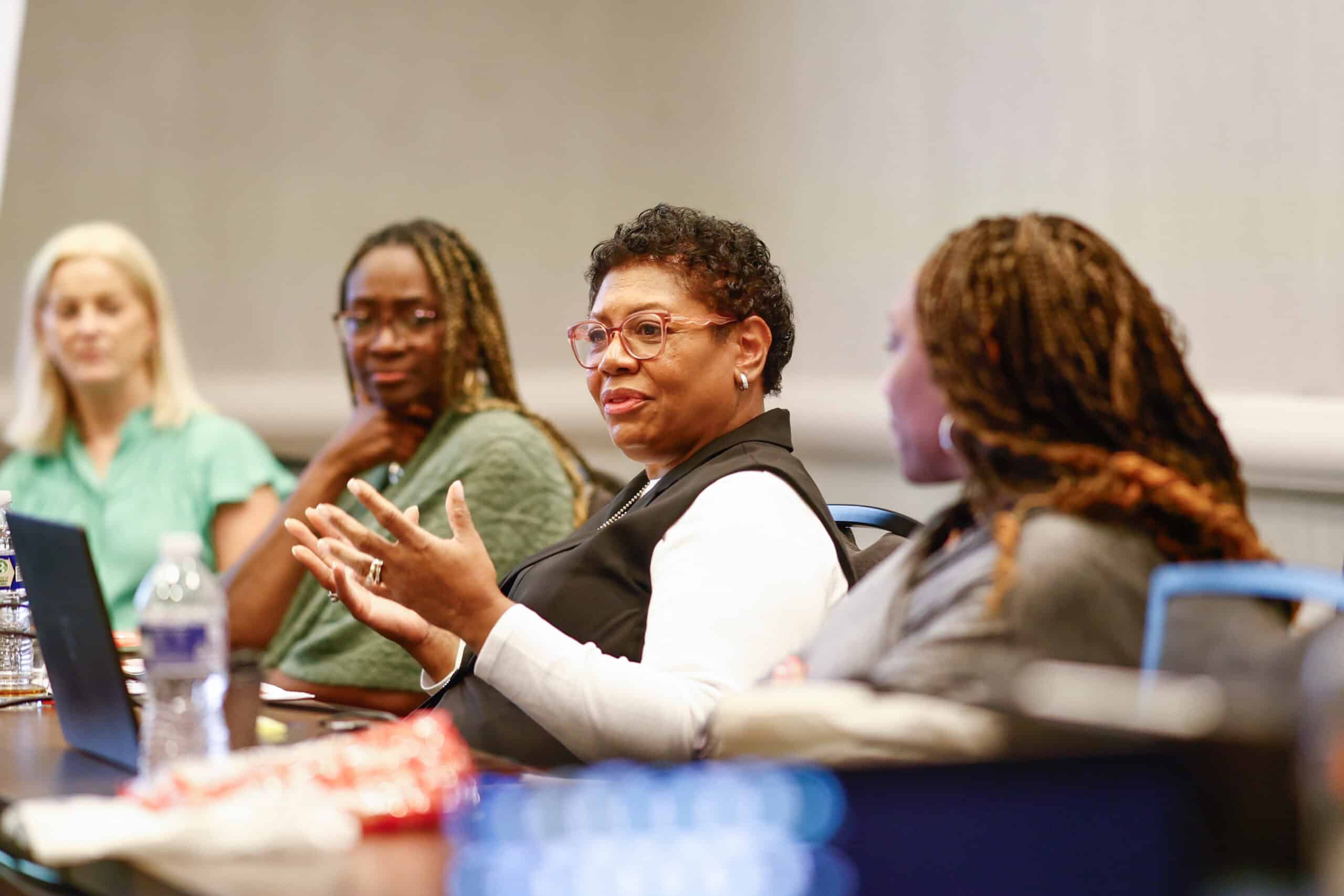 Women in discussion at a conference table