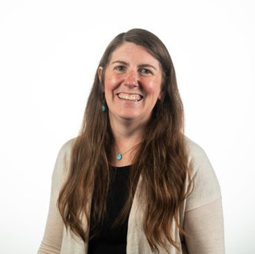 Portrait of a smiling woman with long brown hair on a white background