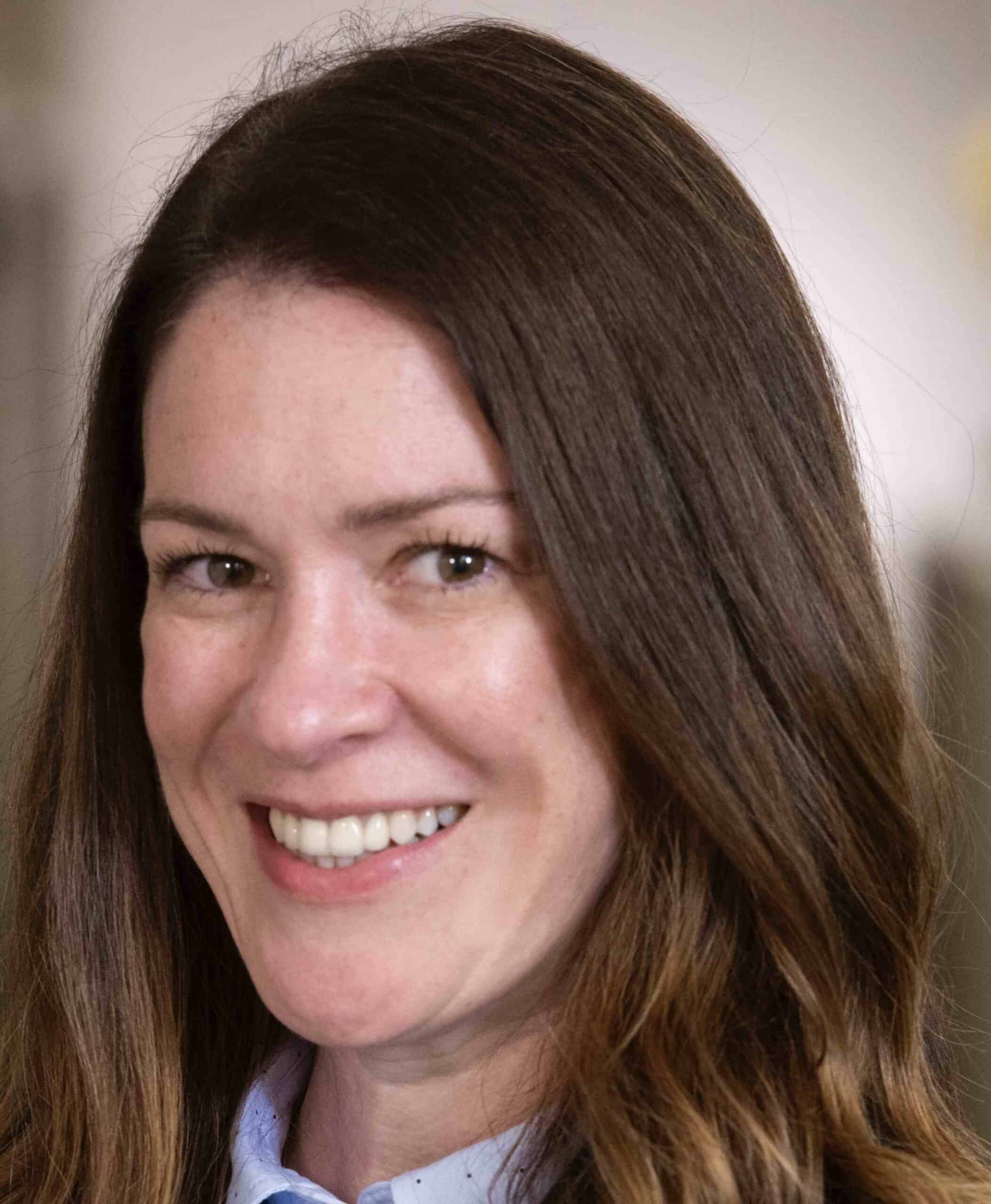 Portrait of a smiling woman with long brown hair
