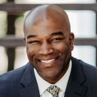 Portrait of a smiling bald man in a suit and tie