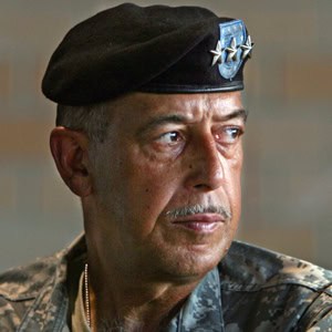 Portrait of a man in military uniform and beret looking to the side