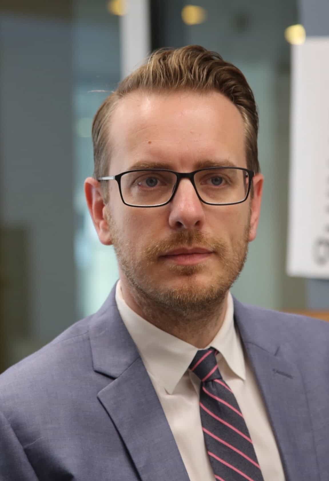 Portrait of a man in a suit and glasses