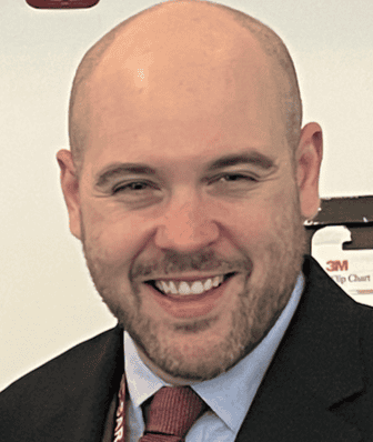 Smiling bald man in a suit and tie