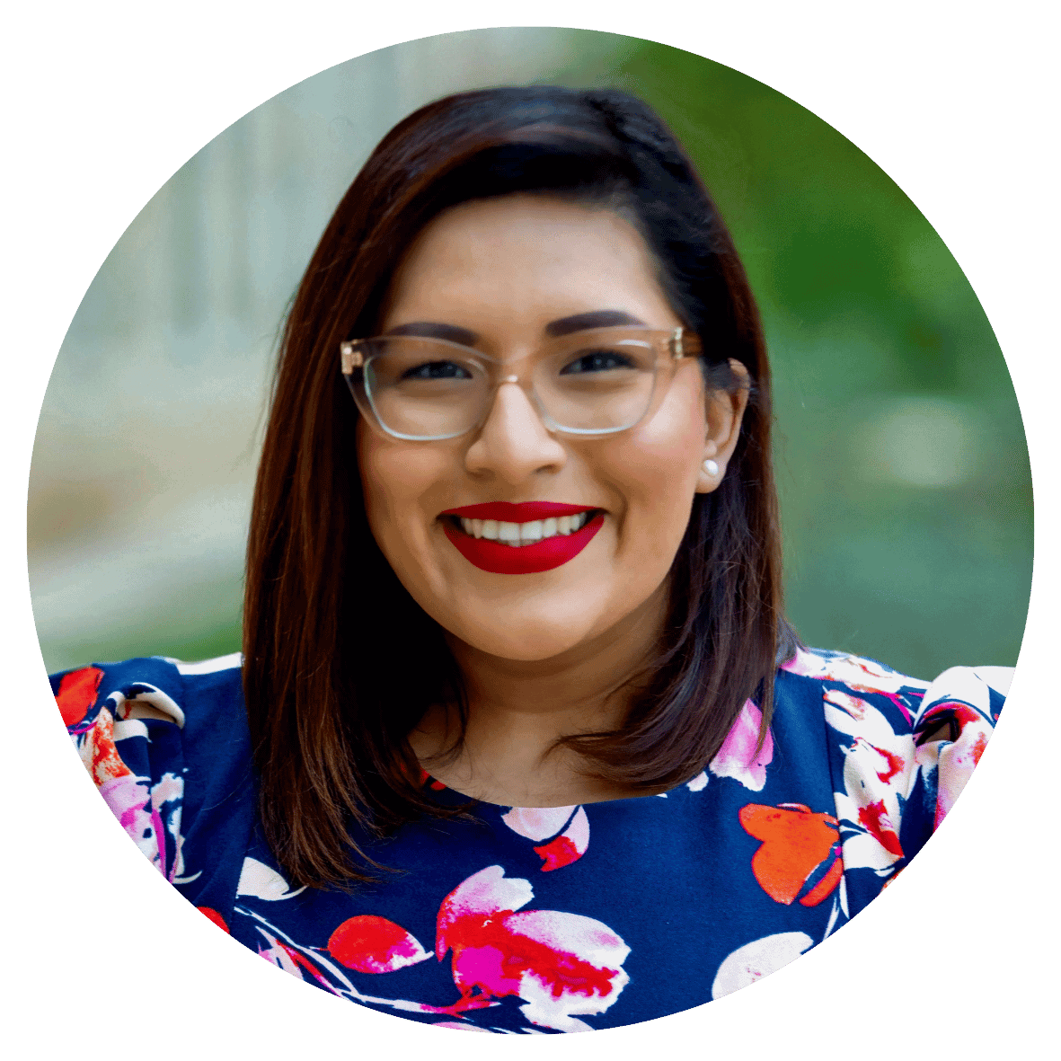 Portrait of a smiling woman wearing glasses and a floral dress