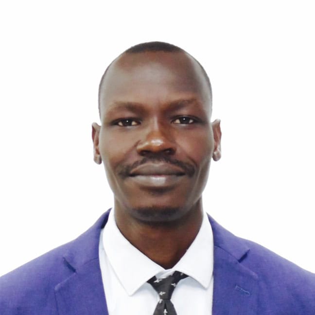 Portrait of a man in a purple suit and tie against a white background
