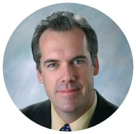 Headshot of a man in a suit and tie