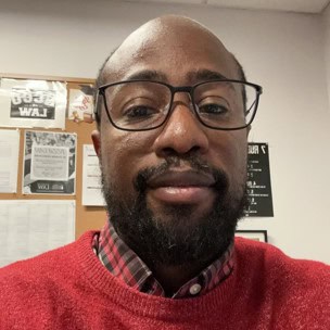Selfie of a man wearing glasses and a red sweater