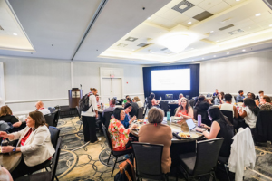 Group of AACRAO Leaders Meeting around Tables.