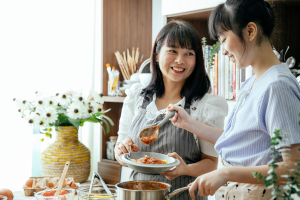 Two individuals cooking.