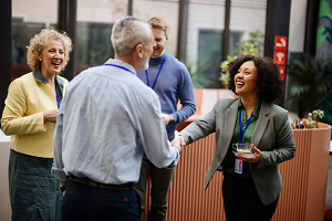 Group of conference attendees welcoming each other.