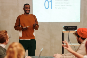 Individual giving a presentation to colleagues.
