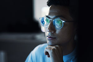 Young professional reviews analytics on a computer.
