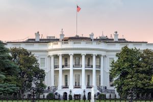 The White House in Washington DC with american flag on sunset sky at sunset