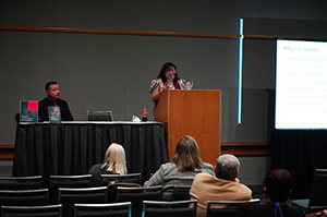 Two presenters speaking to an audience.