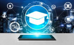 tablet facing upright on a table with a holographic graduation cap coming from the screen