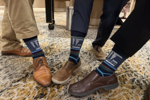 A group of AACRAO members showing their AACRAO socks.