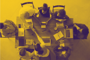 Group of eight people working at a table
