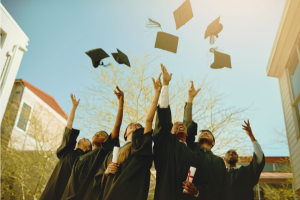Graduating students toss their caps in the air